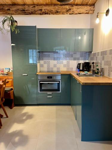 a kitchen with green cabinets and a counter top at Appartamenti La Rocia in Rocca Pietore