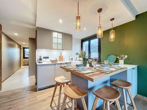 une cuisine avec un grand îlot et des tabourets dans l'établissement Schuss B8, à Morzine