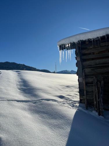 a building with icicles hanging from it in the snow at Hotel B&B VILLA-ALPIN in Grossarl