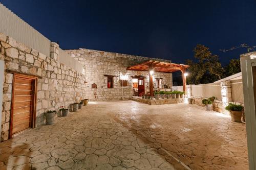 a stone building with a patio at night at Iliada's Traditional Stone House in Paphos City