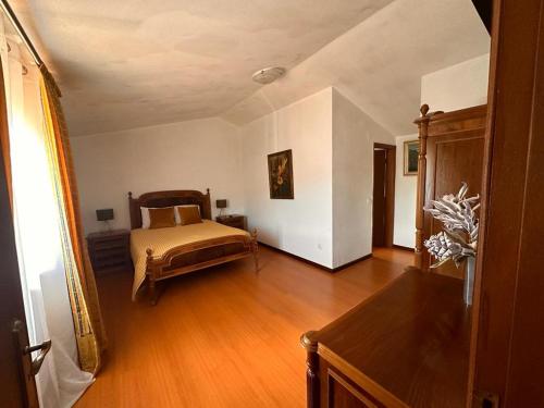 a bedroom with a bed and a wooden floor at Casa Pilar in Reriz