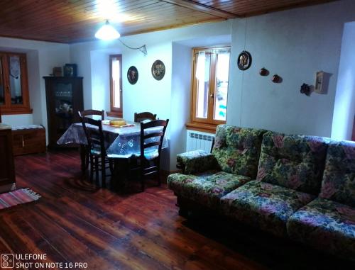 a living room with a couch and a table at Porta sul lago in Campodolcino