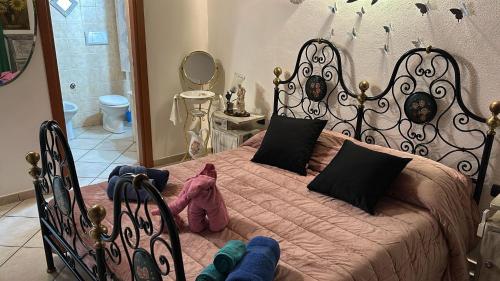 a bedroom with a large bed with a wrought iron headboard at House Baby in Elmas