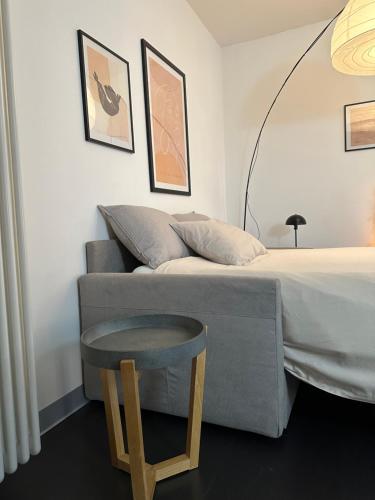 a bedroom with a bed with a table next to it at Civico6 in Tirano