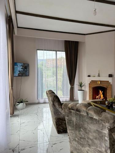 a living room with a couch and a fireplace at MM HOUSE Stepanavan in Stepʼanavan
