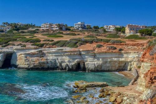 a view of the ocean from a cliff at Villa Best Holiday- breathtaking sea views, amazing garden, private pool, BBQ, next to CORAL BAY, Lower Peyia, Paphos in Peyia