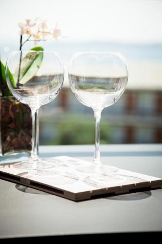 two wine glasses sitting on top of a table at Ayia Marina Suites in Ouranoupoli