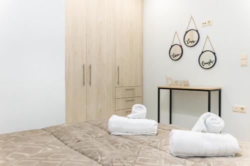 a bedroom with a large bed with two white towels at P&K LUXURY APARTMENTS 1 in Kalamata