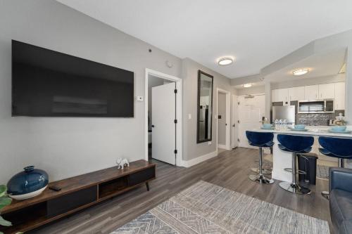 a living room with a large flat screen tv on a wall at Cozy Orlando Getaway with Pool Access in Orlando