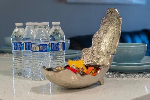 a bird statue sitting on a table with water bottles at Cozy Orlando Getaway with Pool Access in Orlando