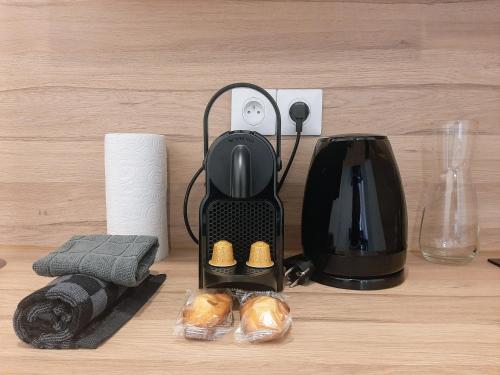 a coffee maker sitting on top of a table at Les Apparts de Marmande - Petit Cocon en ville in Marmande