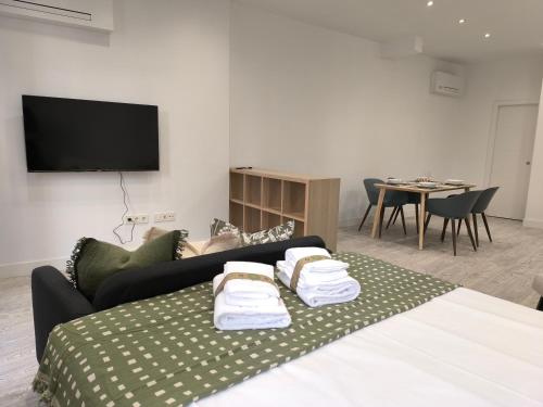a living room with a couch and a table with a tv at INSIDEHOME Ciudad del Cine a 3 minutos de la Plaza Mayor in Valladolid