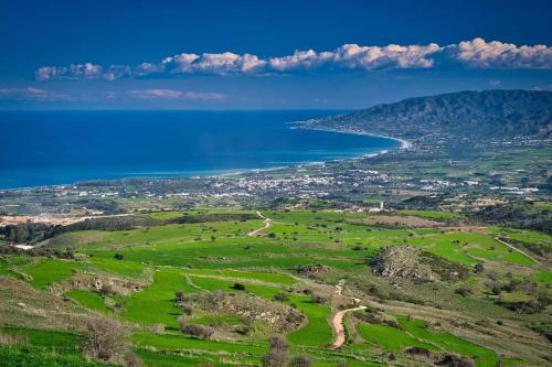 an aerial view of a large body of water at Villa Best Holiday- breathtaking sea views, amazing garden, private pool, BBQ, next to CORAL BAY, Lower Peyia, Paphos in Peyia