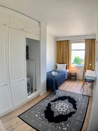 a small bedroom with a bed and a mirror at Kaupunkikoti 3-room apartments D53 in Kemi
