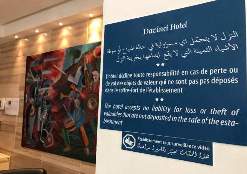 a sign in a room with a painting on the wall at Davinci Beach Resort in Hurghada