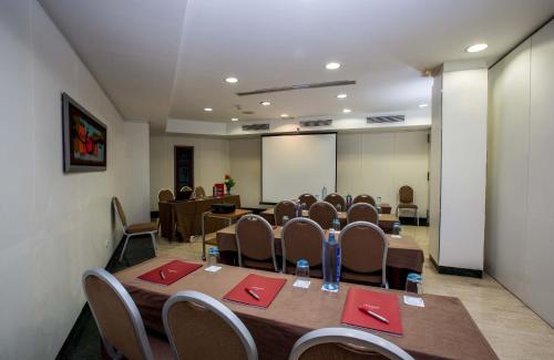 a conference room with a table and chairs and a screen at Leonardo Hotel Madrid City Center in Madrid