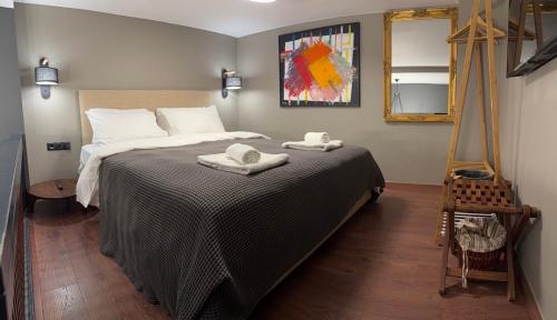 a bedroom with a bed with two towels on it at Smart Home in Thessaloniki