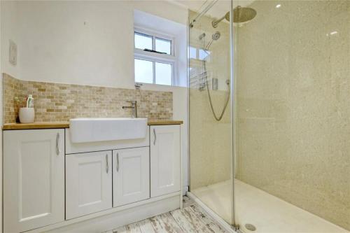 a bathroom with a sink and a shower at Blackbrook Farmhouse in Colchester