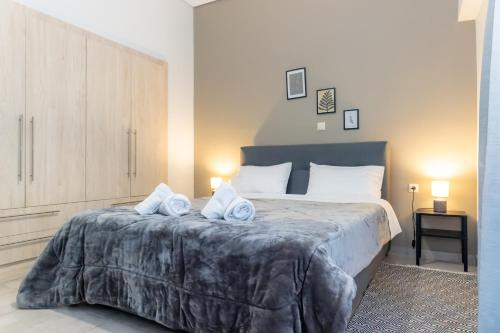 a bedroom with a large bed with towels on it at P&K LUXURY APARTMENTS 2 in Kalamata