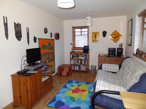 a living room with a couch and a tv at Dullatur in Newtonmore