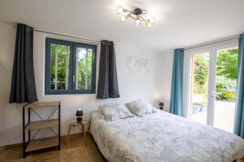 une chambre avec un lit et deux fenêtres dans l'établissement Chez flo et guillaume, à Saint-André-dʼAllas