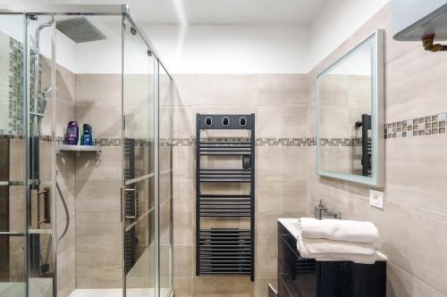 une salle de bain avec une douche en verre et un lavabo dans l'établissement Le Gaïa - A 10min du centre de Nancy, à Nancy