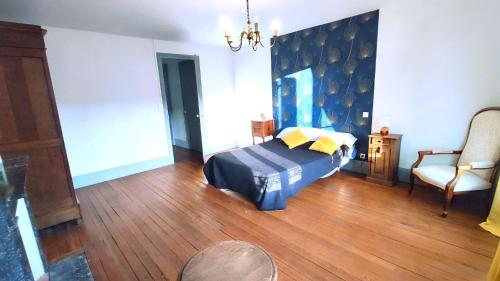 a bedroom with a bed and a couch and a chair at Les rosieres 2 in Dom-le-Mesnil