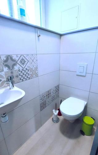 a bathroom with a toilet and a sink at Les rosieres 2 in Dom-le-Mesnil