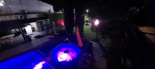 a view of a pool at night with a red light at Quinta Isabel in Ibagué