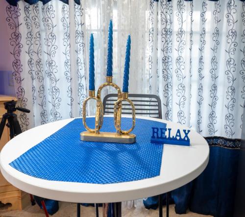 a table with a cake and two candles on it at THE BLUE ROOM Luxury suite in Dover
