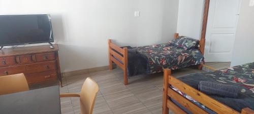 a room with a tv and a bed and a dresser at The Old Fort in Aberdeen