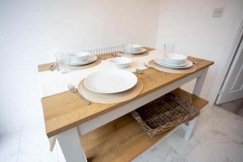 a wooden table with plates and dishes on it at The Getaway in West Monkton