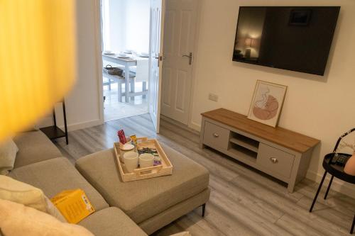 a living room with a couch and a tv at The Getaway in West Monkton