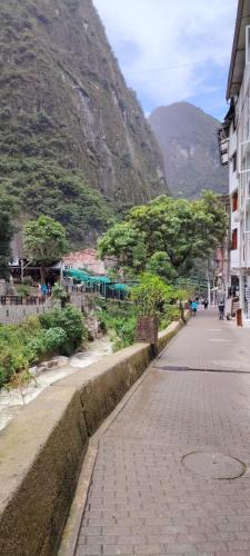 an empty street with a mountain in the background at Viajeros Centro in Machu Picchu