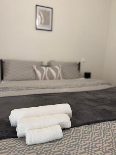 a bedroom with two beds with white towels on the floor at Between Meteora Trikala BMT House in Tríkala