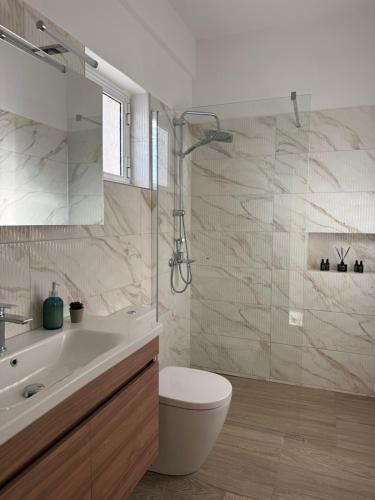 a bathroom with a toilet and a sink and a shower at Between Meteora Trikala BMT House in Tríkala