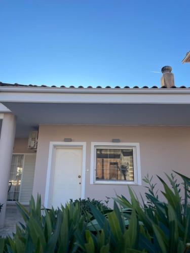 a house with a white door and a window at Between Meteora Trikala BMT House in Tríkala