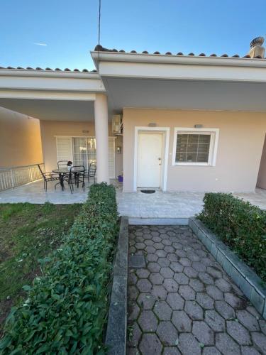 a house with a patio with a table and chairs at Between Meteora Trikala BMT House in Tríkala
