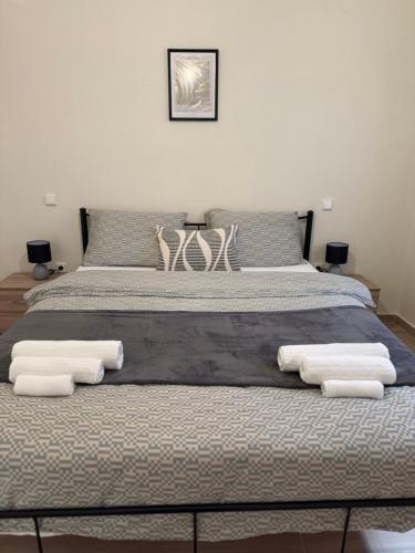 a bedroom with a bed with towels on it at Between Meteora Trikala BMT House in Tríkala