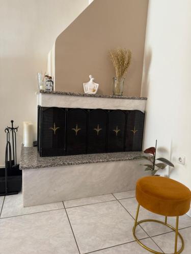 a chair and a counter in a room at Between Meteora Trikala BMT House in Tríkala