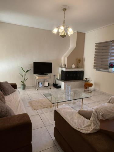 a living room with a couch and a glass table at Between Meteora Trikala BMT House in Tríkala