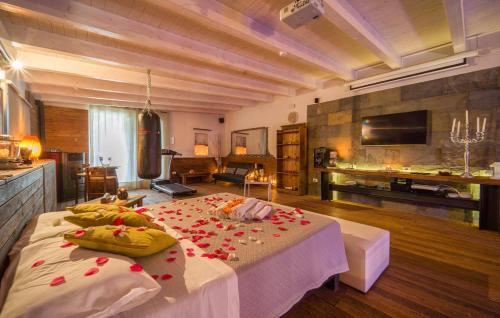 a large room with a bed with flowers on it at Oasi Relax - Romantic Room & Spa in Torretta