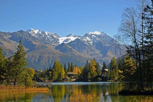 a view of a lake with mountains in the background at Gite du pèlerin-Chalet de montagne jusqu'à 20 personnes in Orsières