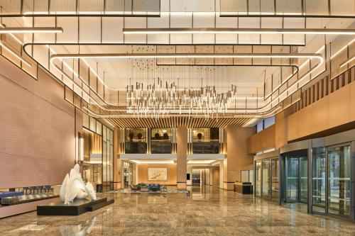a large lobby with a chandelier and a statue at Four Points by Sheraton Xuancheng, Jingxian in Jingxian