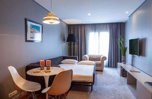 a living room with a couch and a table at Altis Prime Hotel in Lisbon