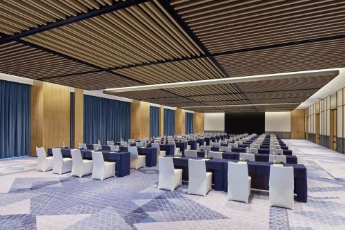 a conference room with blue tables and white chairs at Four Points by Sheraton Xuancheng, Jingxian in Jingxian