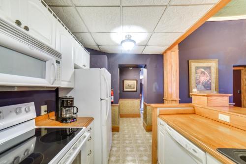 a kitchen with white appliances and purple walls at Yankton Apt 1 Mi to Mount Marty University! in Yankton