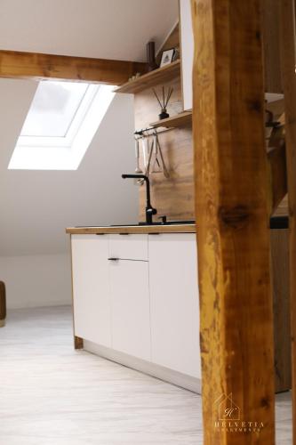 a kitchen with white cabinets and a sink at Helvetia Apartments in Jajce