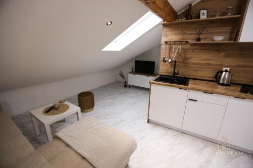 a kitchen with a couch and a table in a room at Helvetia Apartments in Jajce