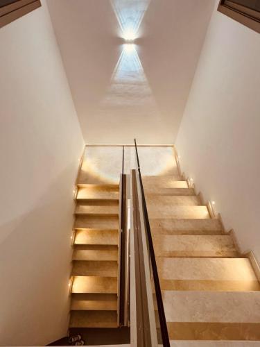 a staircase in a house with a light on the ceiling at Villa Palms de l'Atlas in Marrakech
